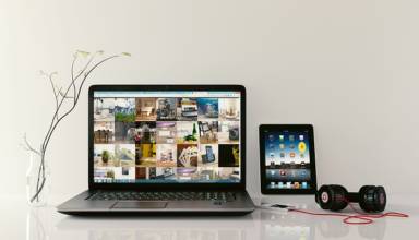 Laptop on table with tablet and headphone