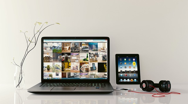 Laptop on table with tablet and headphone