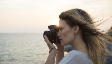 girl using point and shoot camera