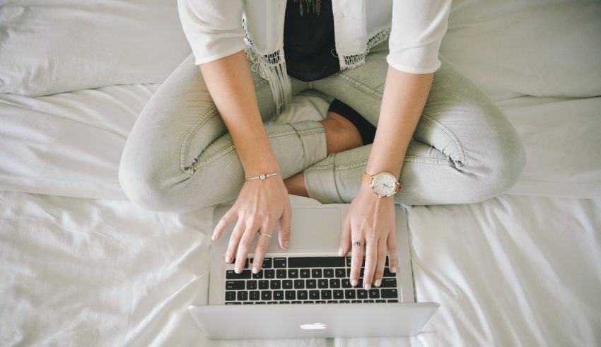 girl writing content on laptop